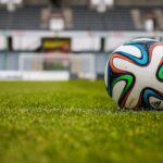 blue orange black green white adidas soccer ball on green field